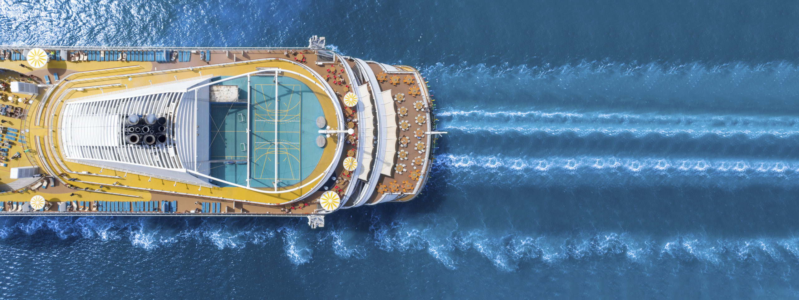 Aerial view of beautiful white cruise ship above luxury cruise c